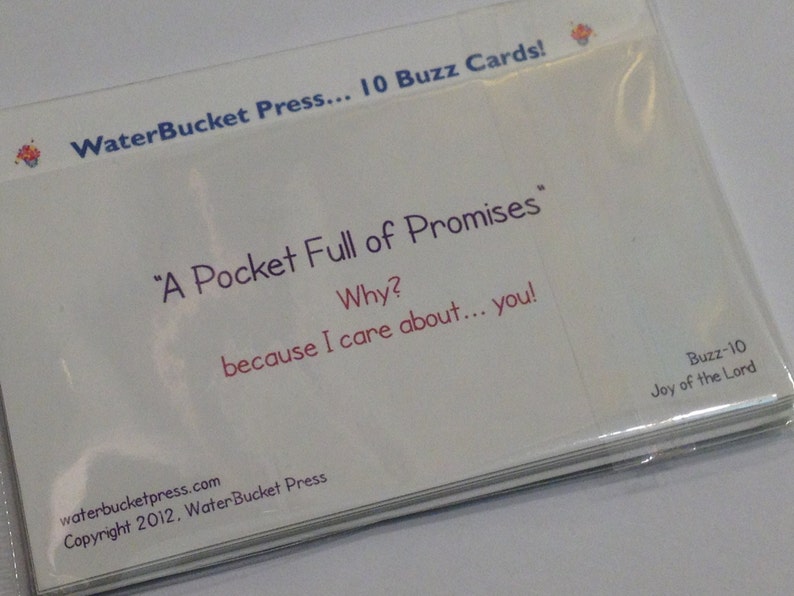 May include: A white card with the text "WaterBucket Press... 10 Buzz Cards!" at the top. The text "A Pocket Full of Promises" is in the center of the card. Below that is the text "Why? because I care about... you!" The text "waterbucketpress.com Copyright 2012. WaterBucket Press" is at the bottom of the card. The text "Buzz-10 Joy of the Lord" is in the bottom right corner of the card.