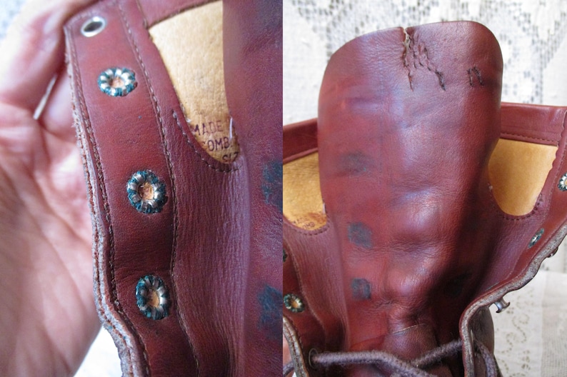 May include: Close-up of a worn, reddish-brown leather boot. The boot features decorative metal eyelets and a distressed appearance. The interior shows a tan lining and a label with text.