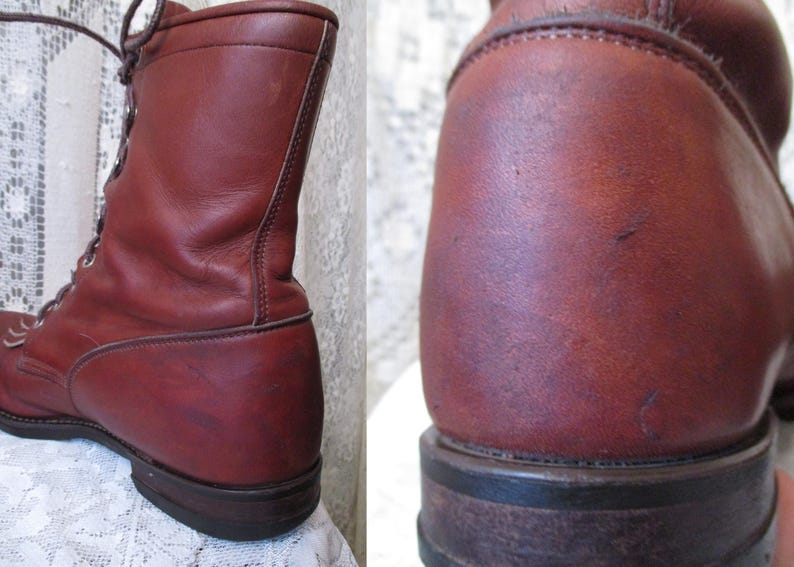 May include: A pair of reddish-brown leather boots. The boots are lace-up style with a rounded toe and a sturdy sole. The leather has a slightly worn appearance, suggesting vintage or well-loved footwear.