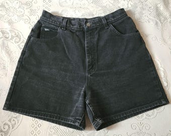 May include: Black denim shorts with a high waist and a button closure. The shorts have front and back pockets and a classic, casual style. The fabric appears to be a medium-weight denim.