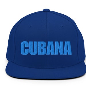 May include: A blue baseball cap with the word 'CUBANA' embroidered in light blue on the front.