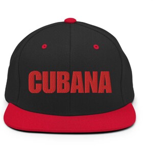 May include: A black and red baseball cap with the word 'CUBANA' embroidered in red on the front.
