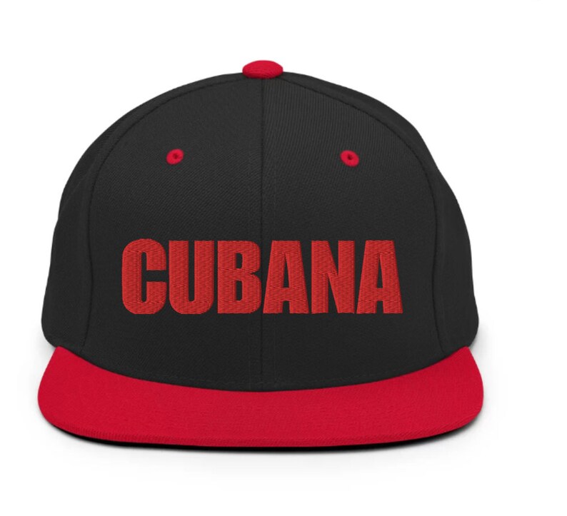 May include: A black and red baseball cap with the word 'CUBANA' embroidered in red on the front.