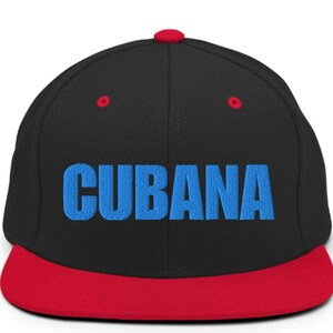 May include: A black and red baseball cap with a blue embroidered word 'CUBANA' on the front.