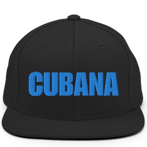 May include: A black and blue baseball cap with the word 'CUBANA' embroidered in blue on the front.