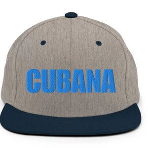 May include: A gray and blue baseball cap with a blue embroidered word 'CUBANA' on the front