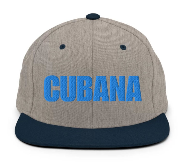 May include: A gray and blue baseball cap with a blue embroidered word 'CUBANA' on the front