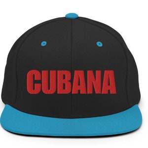 May include: A black and blue baseball cap with the word 'CUBANA' embroidered in red on the front.