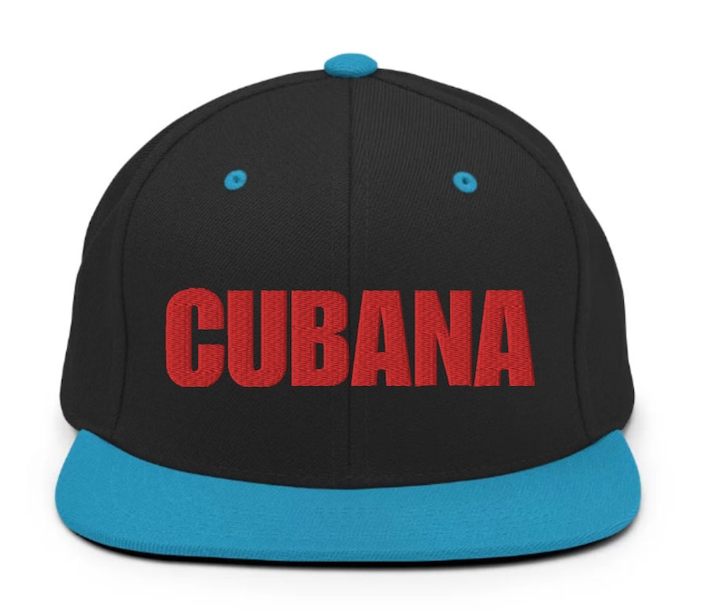 May include: A black and blue baseball cap with the word 'CUBANA' embroidered in red on the front.