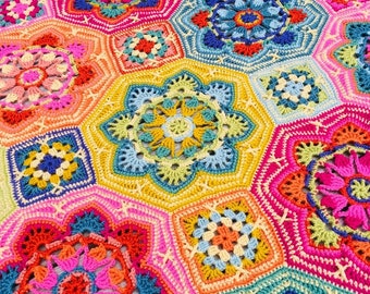 May include: A handmade crochet blanket featuring a vibrant mosaic of interconnected hexagonal and square motifs. The design showcases a kaleidoscope of colors including hot pink, bright yellow, turquoise, orange, and lime green in intricate floral patterns.