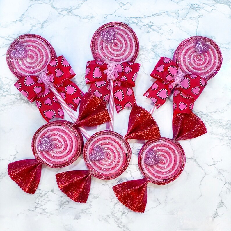 Red and pink foam valentine lollipops and candy, hand painted with glitter.