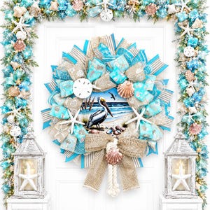 May include: A coastal-themed wreath with a pelican painting at its center, surrounded by turquoise and beige ribbons, seashells, and starfish. The wreath is adorned with a large burlap bow and rope detail, creating a nautical aesthetic. The image also includes matching garland and lanterns.