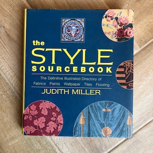 May include: A hardcover book titled "the STYLE SOURCEBOOK" with a dark blue cover and yellow lettering. The book features illustrations of fabrics, wallpaper, and flooring. The author's name, JUDITH MILLER, is printed at the bottom.