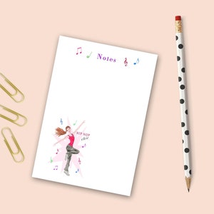May include: A white notepad with the word "Notes" printed in purple at the top. The notepad features a pink and white illustration of a woman dancing with the words "Hip Hop Chic" printed in black. The illustration is surrounded by musical notes in various colors.