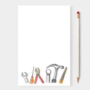 May include: A white notepad with a pencil and a pencil-drawn illustration of tools. The tools include a wrench, screwdriver, pliers, a hammer, and a saw. The pencil is white with a red eraser.