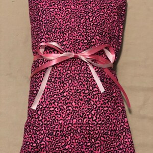 May include: Pink leopard print fabric heat pack tied with a pink ribbon.