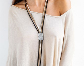 Statement necklace, Leather necklace, Long necklace, Wrapped necklace, Stylish necklace, Silver necklace, Elegant necklace, Large necklace.