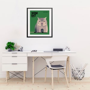 May include: A framed illustration of a wombat, a marsupial native to Australia. The illustration is in a minimalist style with a green background and black text that reads "Wombat" and "FAMILY: VOMBATIDAE".