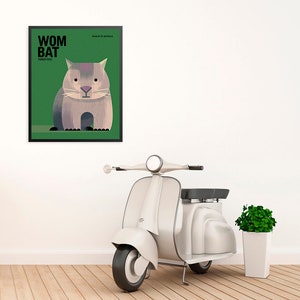 May include: A framed poster with a green background and a cartoon illustration of a wombat. The poster has the text "WOMBAT" in black letters and the text "VOMBATIDAE" in smaller black letters. The poster is hanging on a white wall next to a white scooter and a potted plant.