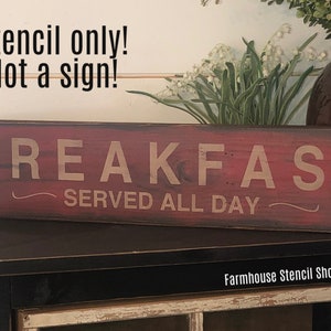 May include: A rectangular wooden sign with the words "BREAKFAST SERVED ALL DAY" in a light color against a red background. The sign is a stencil and is not a finished sign. The text "Stencil only! Not a sign!" is above the sign.