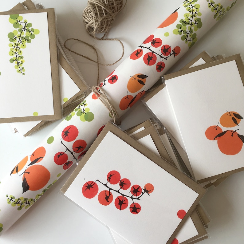 May include: A stack of blank greeting cards with brown envelopes. The cards feature a variety of colorful illustrations, including grapes, tomatoes, and oranges. The cards are perfect for sending a handwritten note to a loved one.