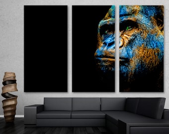 May include: A close-up of a gorilla's face, with blue and gold paint accents, against a black background.
