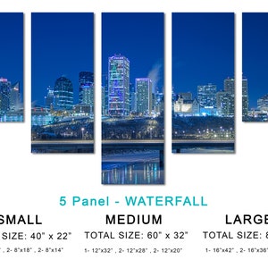 May include: A five-panel canvas print of a cityscape at night. The image shows illuminated skyscrapers and buildings against a dark blue sky. The print is labeled "5 Panel - Waterfall" and lists sizes: Small (40" x 22"), Medium (60" x 32"), and Large (80" x 42").
