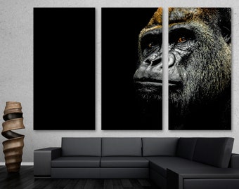 May include: A close-up of a gorilla's face, with a black background. The gorilla's eyes are highlighted in orange, and its fur is dark and textured.