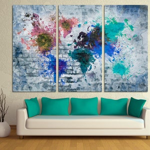 May include: A three-panel canvas wall art featuring a world map with colorful paint splatters on a gray brick background.