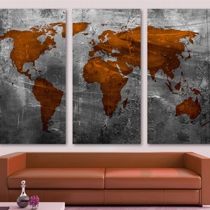 May include: A three-panel canvas print featuring a world map in a rusty orange color on a gray, textured background.