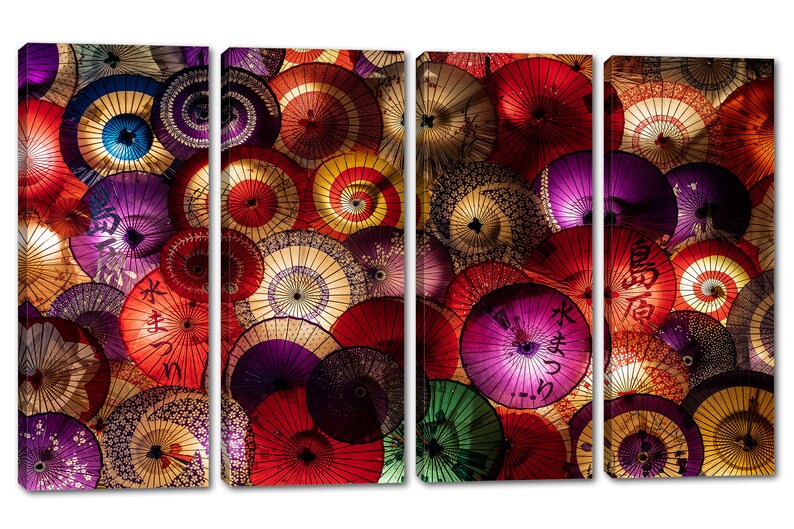 May include: A colorful wall art print featuring a close-up of a collection of Japanese paper umbrellas. The umbrellas are arranged in a random pattern and feature various colors, including red, purple, green, and yellow. The umbrellas have intricate designs and patterns, including floral motifs and Japanese characters.