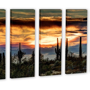 May include: A five-panel canvas print depicting a desert sunset. Silhouetted saguaro cacti stand in the foreground against a vibrant sky of orange, yellow, and purple hues. The artwork captures the serene beauty of the desert landscape.