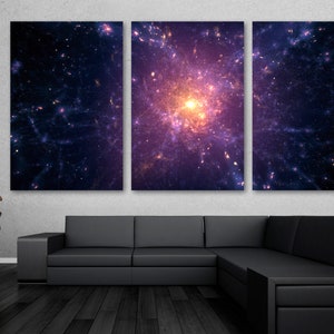 May include: A tri-panel canvas print featuring a vibrant nebula with a bright, yellow-orange core surrounded by swirling purple and blue hues. The nebula is set against a dark blue background with scattered stars.