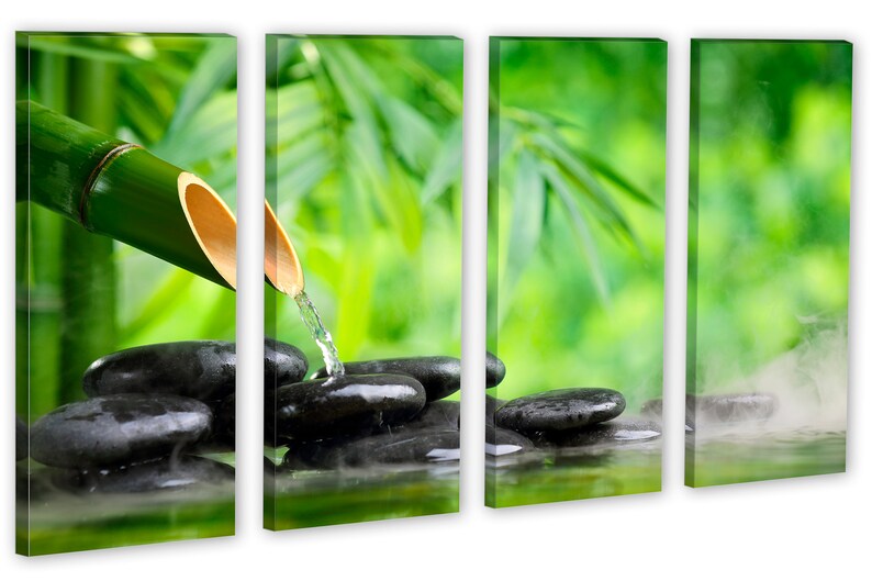 May include: A bamboo shoot pours water over smooth black stones in a zen garden setting. The background is a blurred image of green leaves.