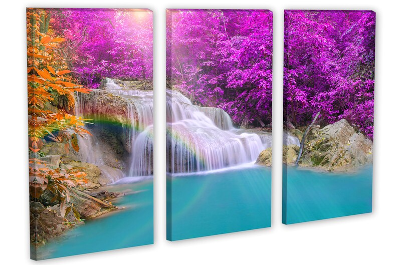 May include: A three-panel canvas print featuring a waterfall cascading through a lush forest. The water is crystal clear and the forest is a vibrant mix of green and purple.