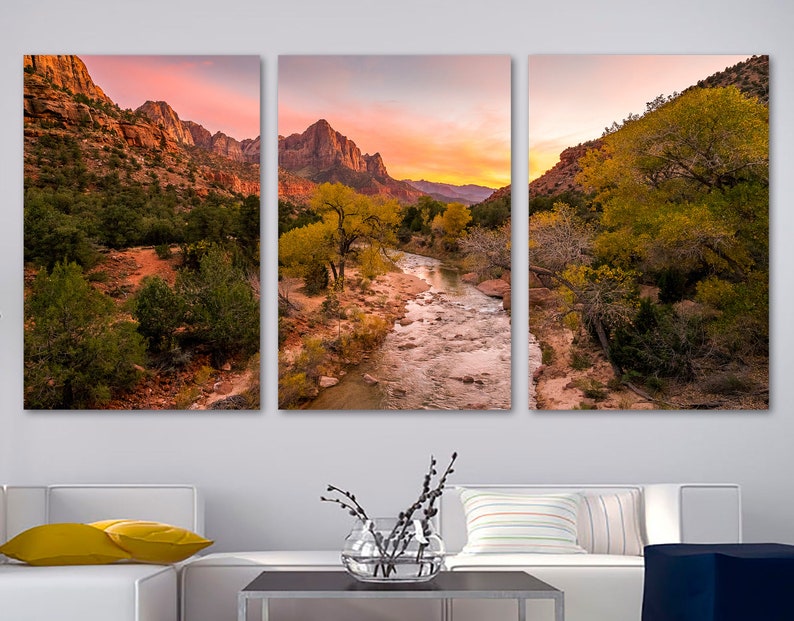 Zion National Park Canvas Print Wall Art , it is on three canvases but is one picture, a photograph of the river and the canyon walls in the background with trees next to the river, the canvases are mounted on a wall with a sofa and table in front