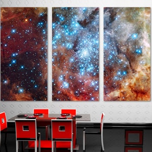 May include: A three-panel canvas print featuring a colorful nebula with stars and galaxies. The print is a vibrant mix of red, blue, and orange hues.