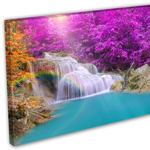 May include: A vibrant waterfall cascades down a rocky cliff, surrounded by lush foliage. The water is a bright turquoise, and a rainbow arches over the falls. The trees in the background are a vibrant purple.