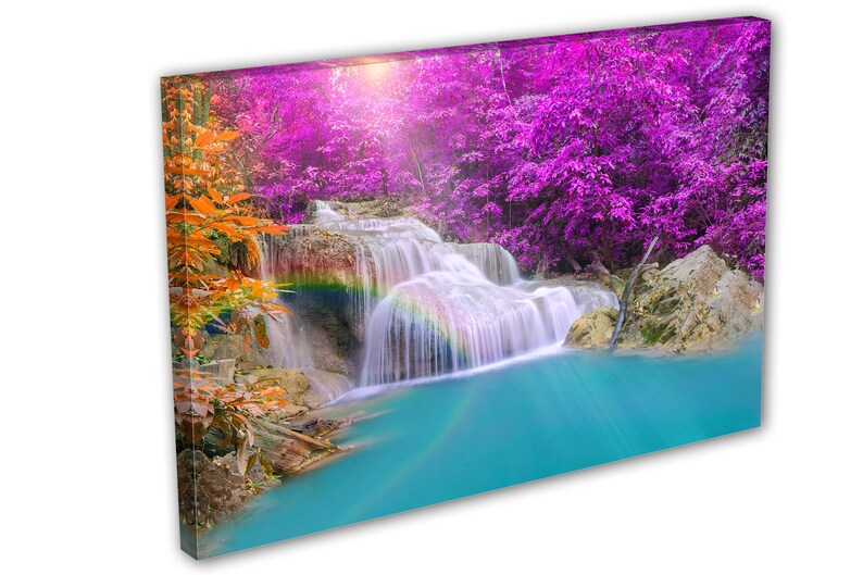 May include: A vibrant waterfall cascades down a rocky cliff, surrounded by lush foliage. The water is a bright turquoise, and a rainbow arches over the falls. The trees in the background are a vibrant purple.