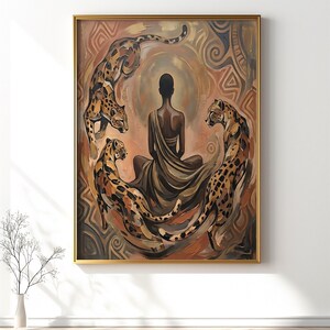 May include: An artistic painting featuring a person in a meditative pose surrounded by three leopards. The artwork is framed in gold and has a warm color palette of browns, oranges, and tans. The leopards have black spots and are positioned around the central figure.