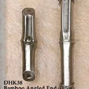 May include: Two silver bamboo-style door hardware pieces. The larger piece is a 5-inch pull with an angled end. The smaller piece is a 2-1/2-inch knob with an angled end.