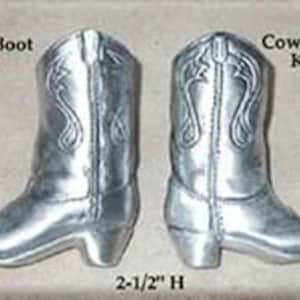 May include: Two silver-colored cowboy boot knobs, labeled "DHK56 Cowboy Boot Knob left" and "DHK55 Cowboy Boot Knob right." Each boot is 2.5 inches high. The knobs are detailed with stitching and decorative elements.