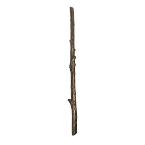 May include: A long, thin, brown twig with a rough texture. The twig is made of metal and has a rustic look.