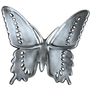 May include: A silver-colored butterfly-shaped decorative object. The butterfly has detailed wing patterns with small, evenly spaced holes along the edges. The wings are spread wide, and the body is slender.