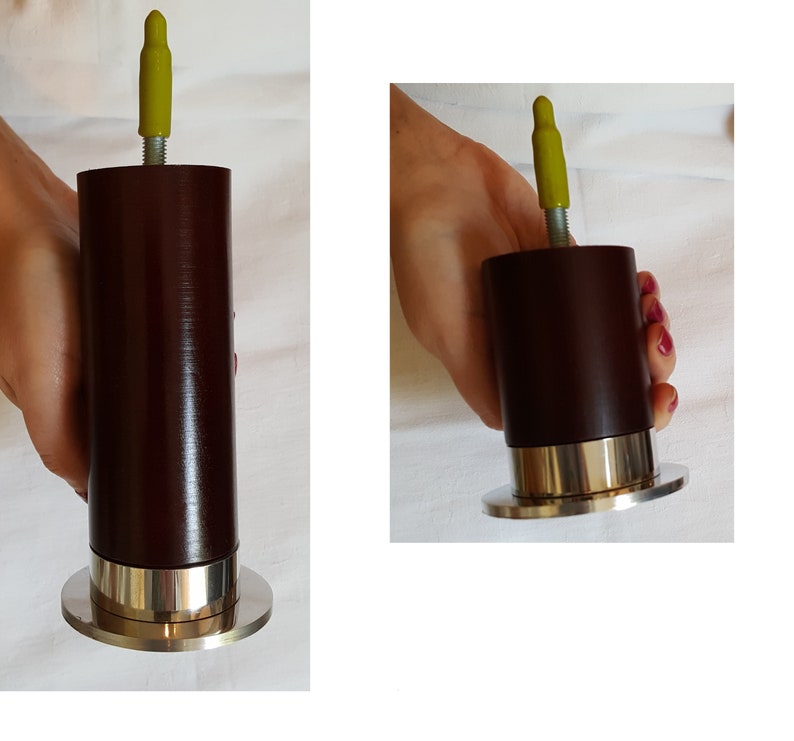 May include: A dark brown wooden furniture leg with a silver metal base and a yellow plastic cap on top.