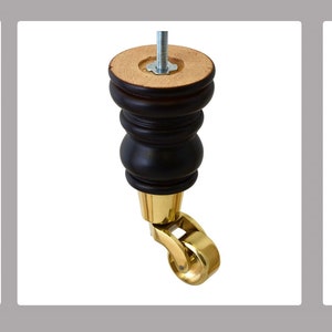 May include: Three black wooden furniture legs with copper-colored wheels. One single black wooden furniture leg with a gold-colored wheel. One single light brown wooden furniture leg with a dark brown wheel.