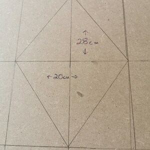 This picture shows the diamond shape being mapped out on the wood of the headboard.