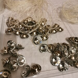This picture shows the crystal buttons being threaded, ready to be used on the headboard.