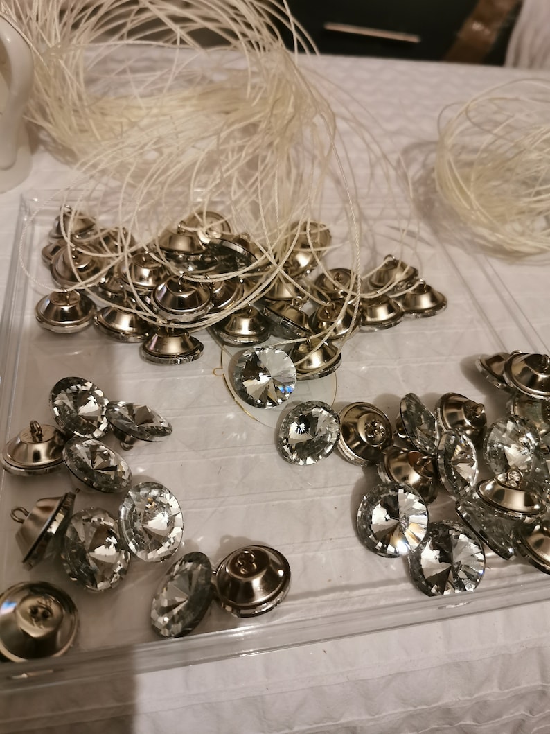 This picture shows the crystal buttons being threaded, ready to be used on the headboard.