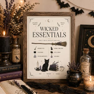May include: A framed print titled Wicked Essentials featuring illustrations of a broomstick, a black cat, spell books, and potion ingredients. The text reads Quality Witch Supplies Since 1657, Open Until Midnight, Witches Only, and Past, Present, Future. The print is in a brown wooden frame.